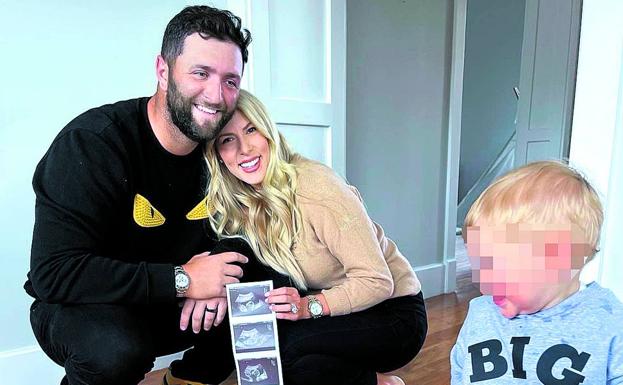Jon Rahm and Kelly Cahill smile with their son Kepa at their home in Arizona. 