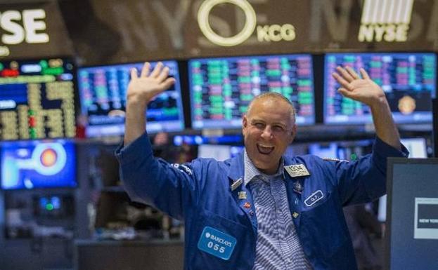 A trader celebrates his earnings on Wall Street. 