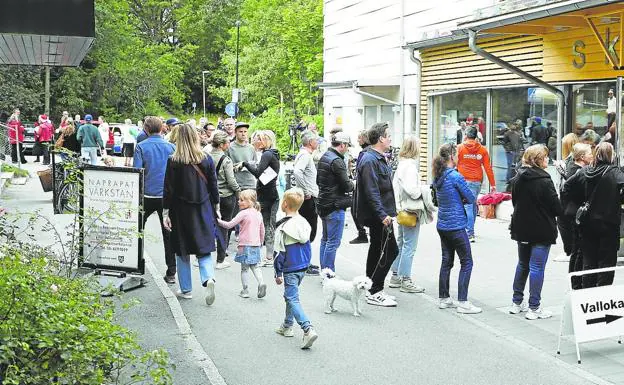 Many voters wait in front of a polling station to vote in Nacka, a municipality in Stockholm.